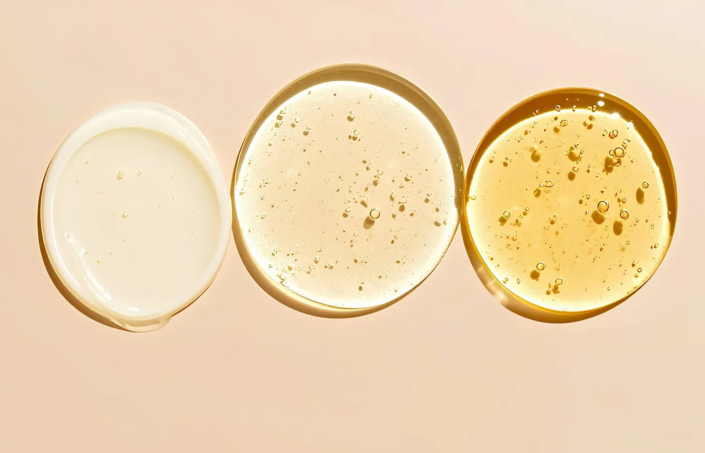 Minimal skincare textures in cream, gel, and golden serum tones